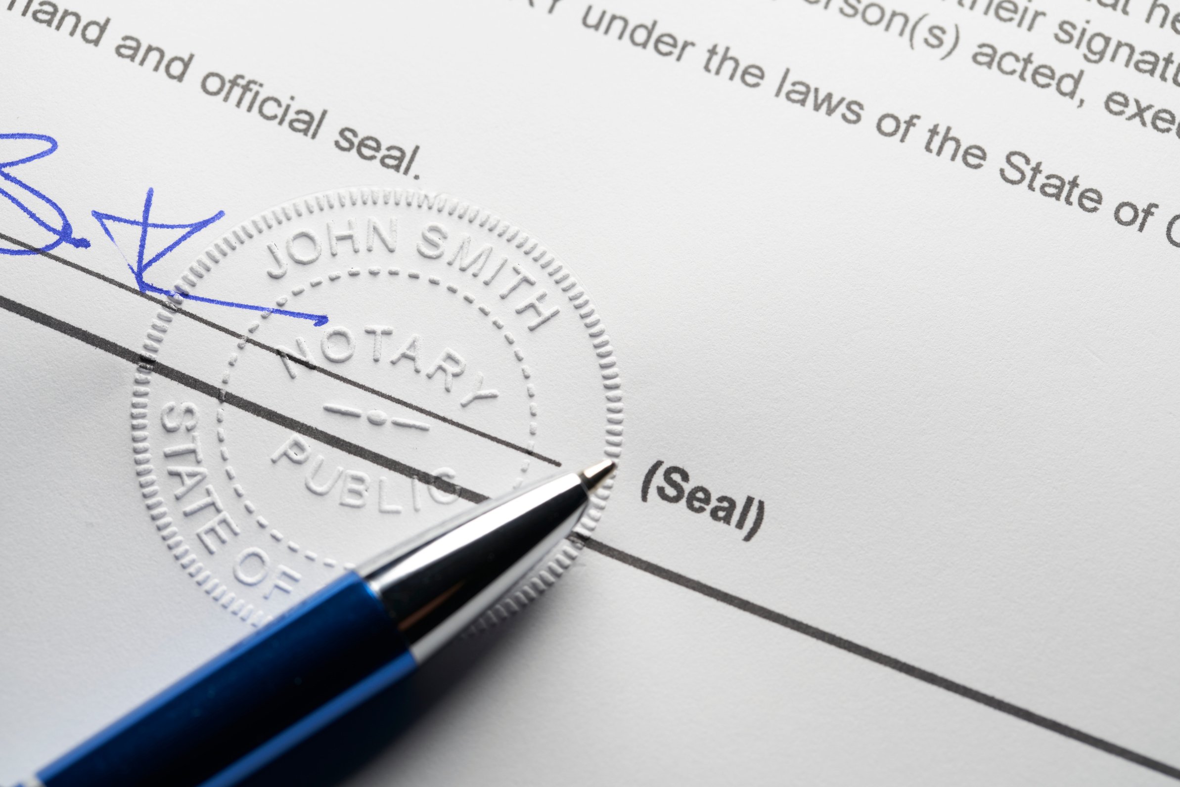 Notary Public: Seal embossed on document with pen